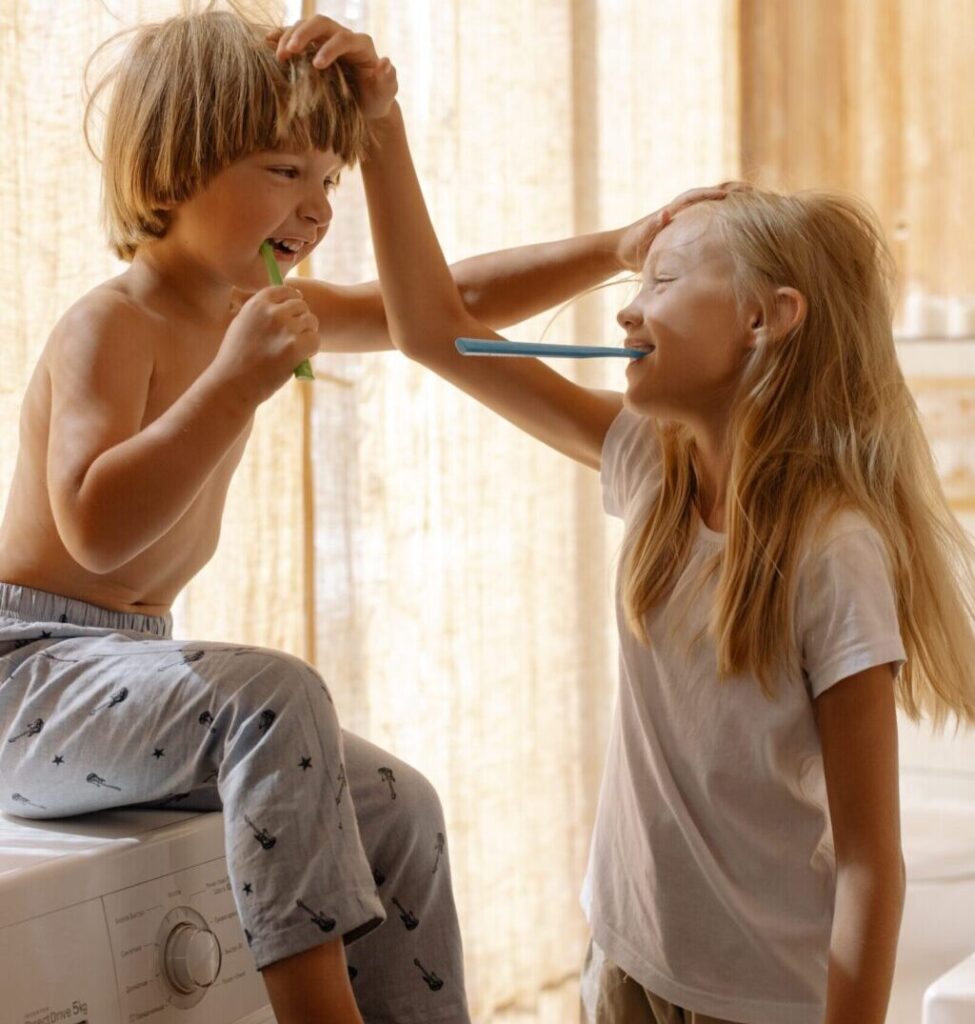 children brushing their teeth playfully