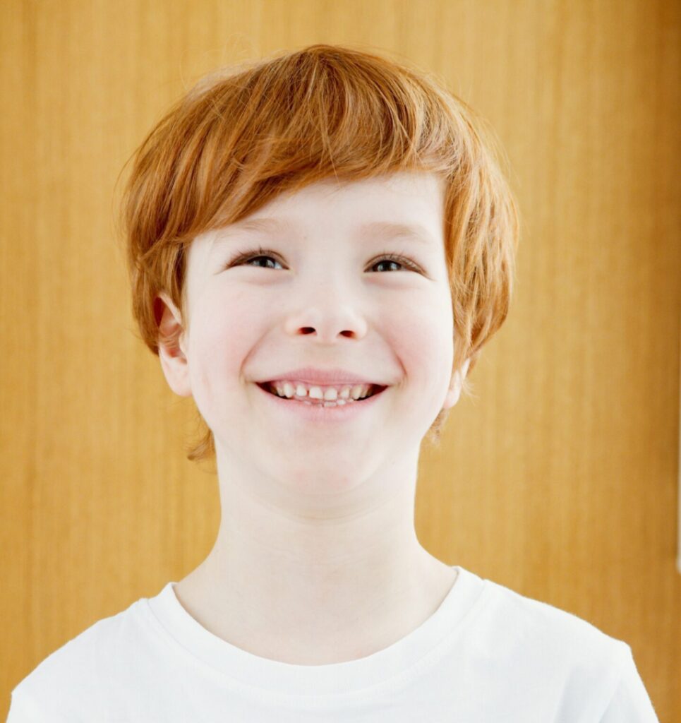 smiling boy with red hair