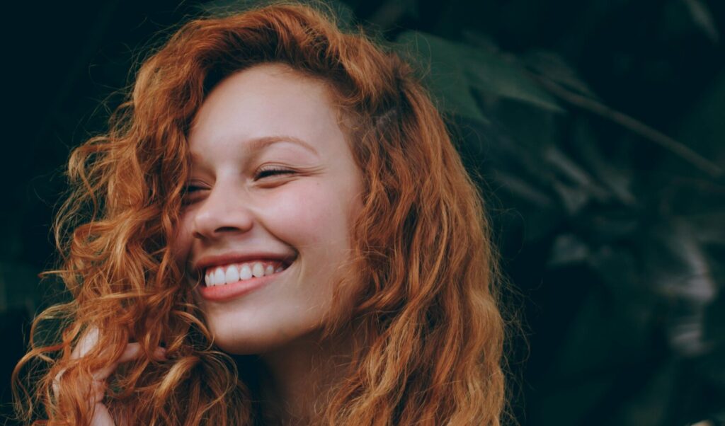 young red-headed woman smiling